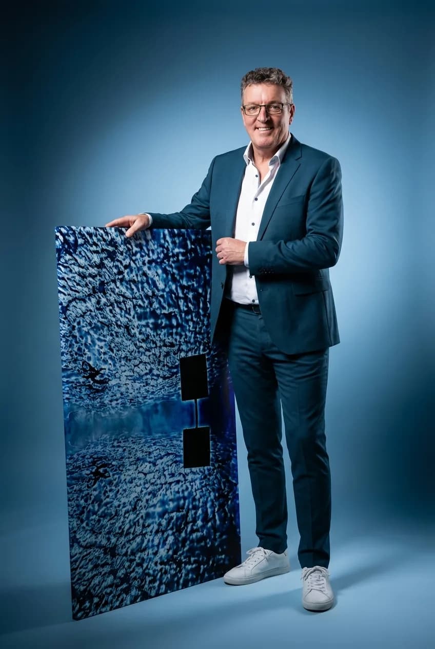 Ed Reininga with one of his acrylic face-mount works